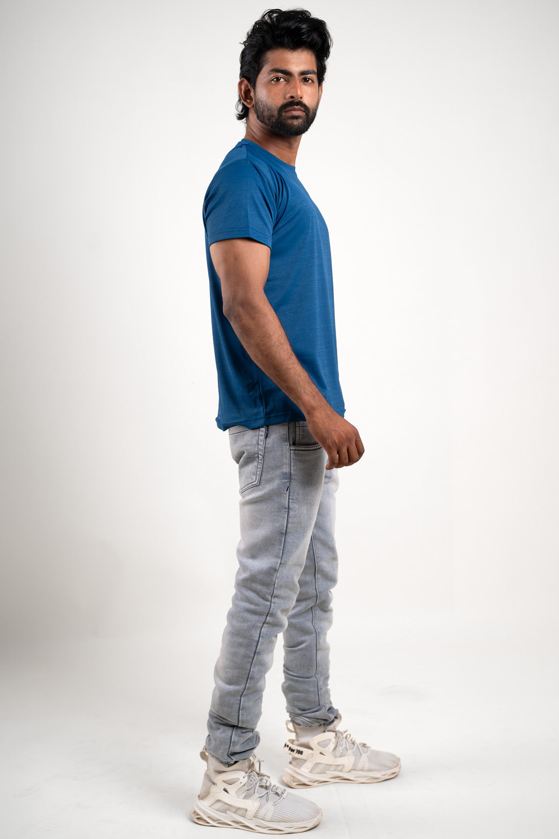 Profile view of the blue crew neck t-shirt, showcasing its essential role in everyday wear