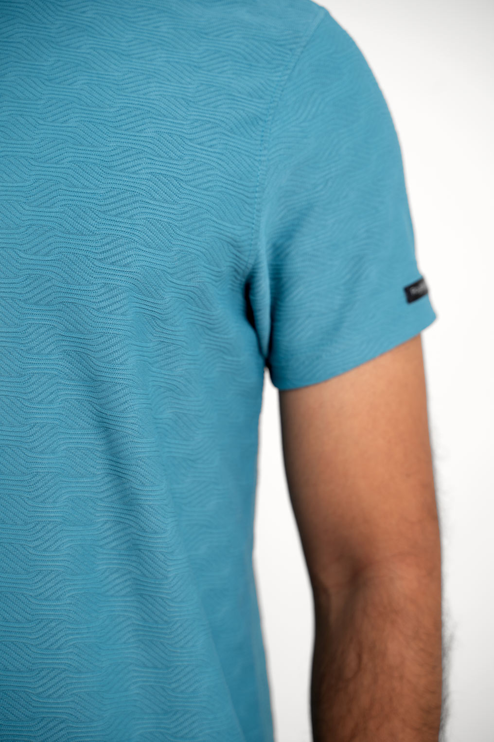 man wearing blue tshirt hand closeup view