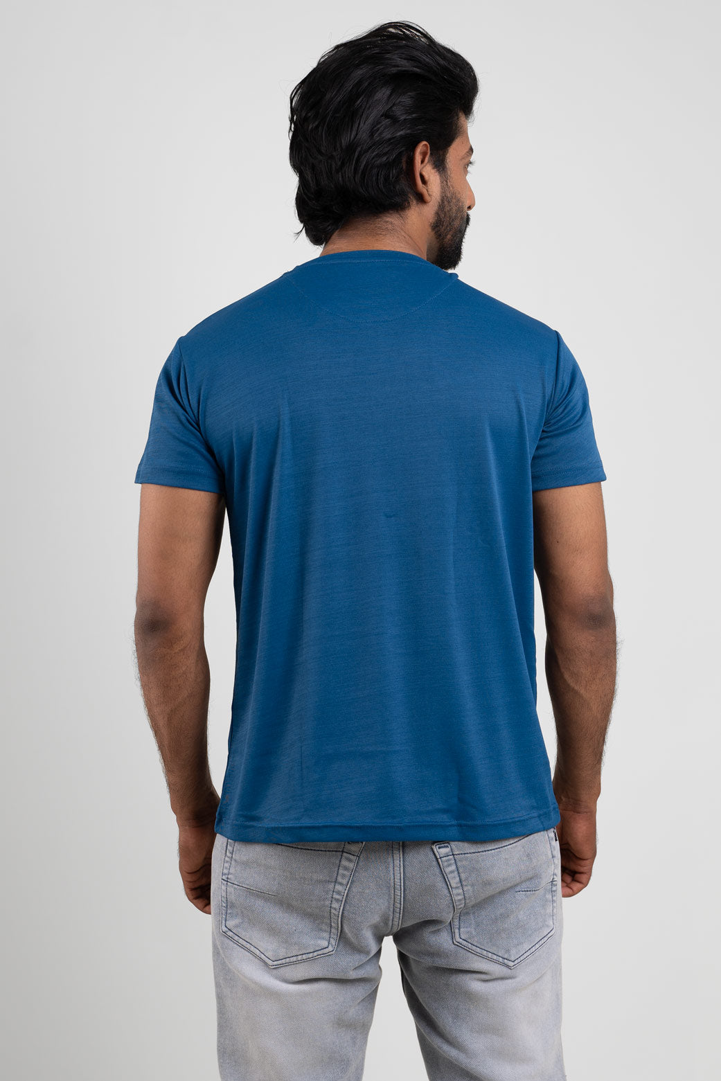 Back view of the blue crew neck t-shirt, illustrating its simple and clean aesthetic