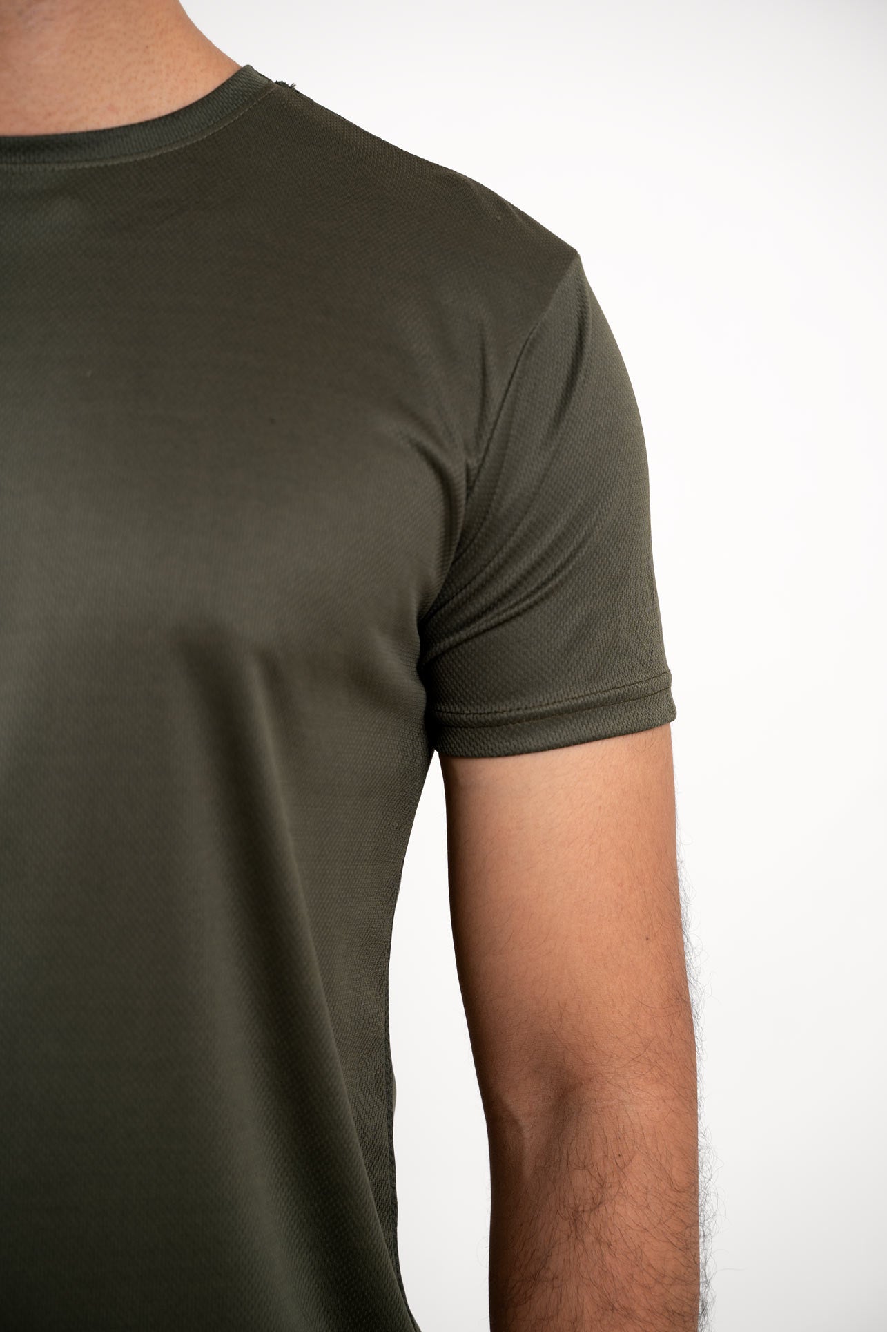 Close-up shot of the olive crew neck t-shirt's fabric, revealing its breathable and moisture-wicking properties