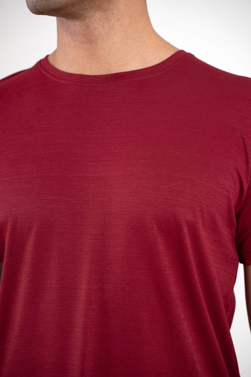 Detailed image of the neckline of the red round neck t-shirt, emphasizing its clean and neat finish