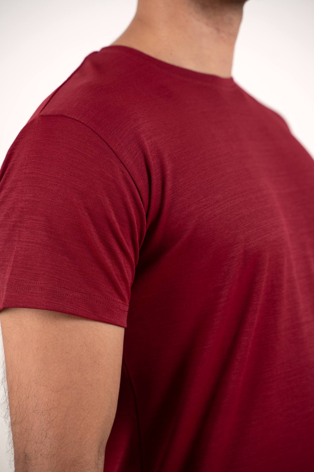 Close-up shot of the fabric of the red t-shirt, revealing its smooth texture and vibrant color