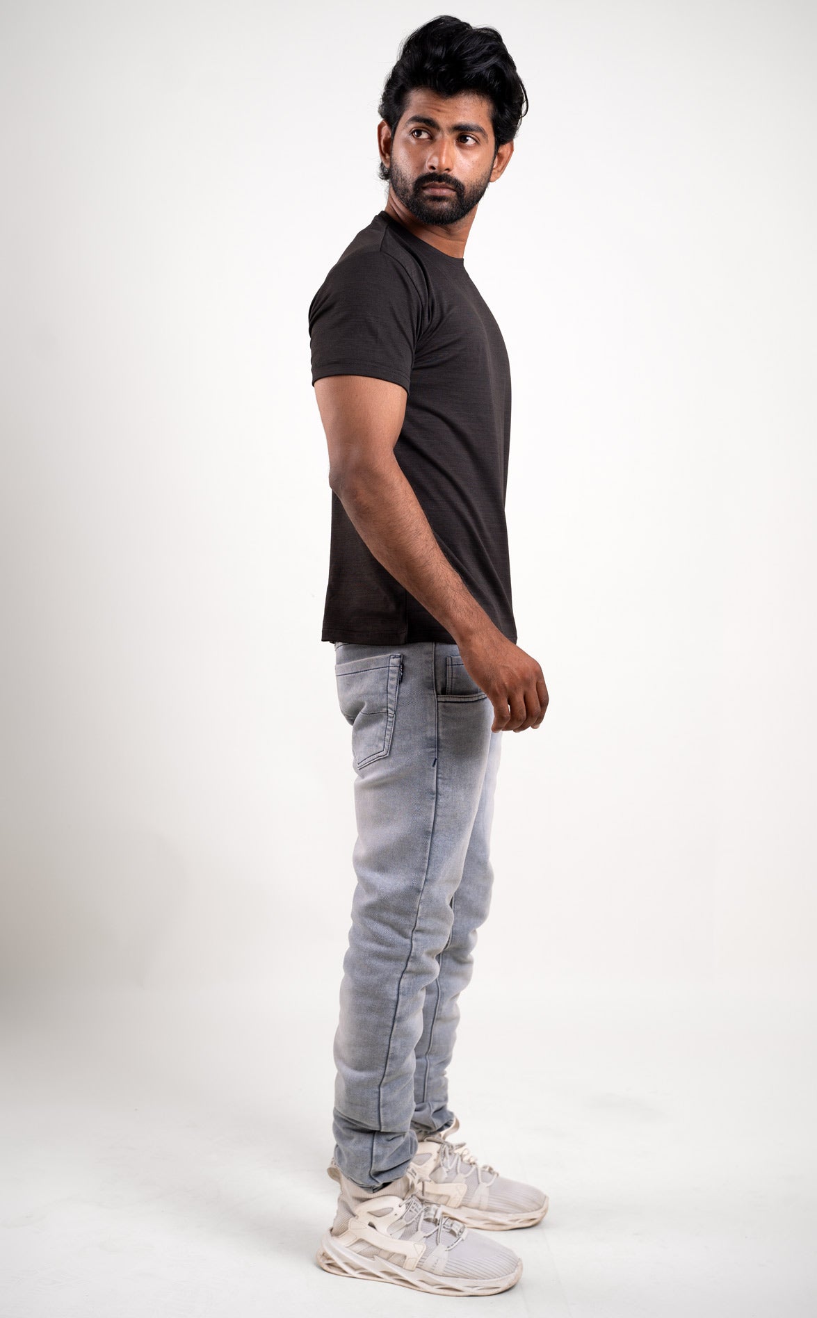 Profile view of the black crew neck t-shirt, highlighting its essential role in everyday wear