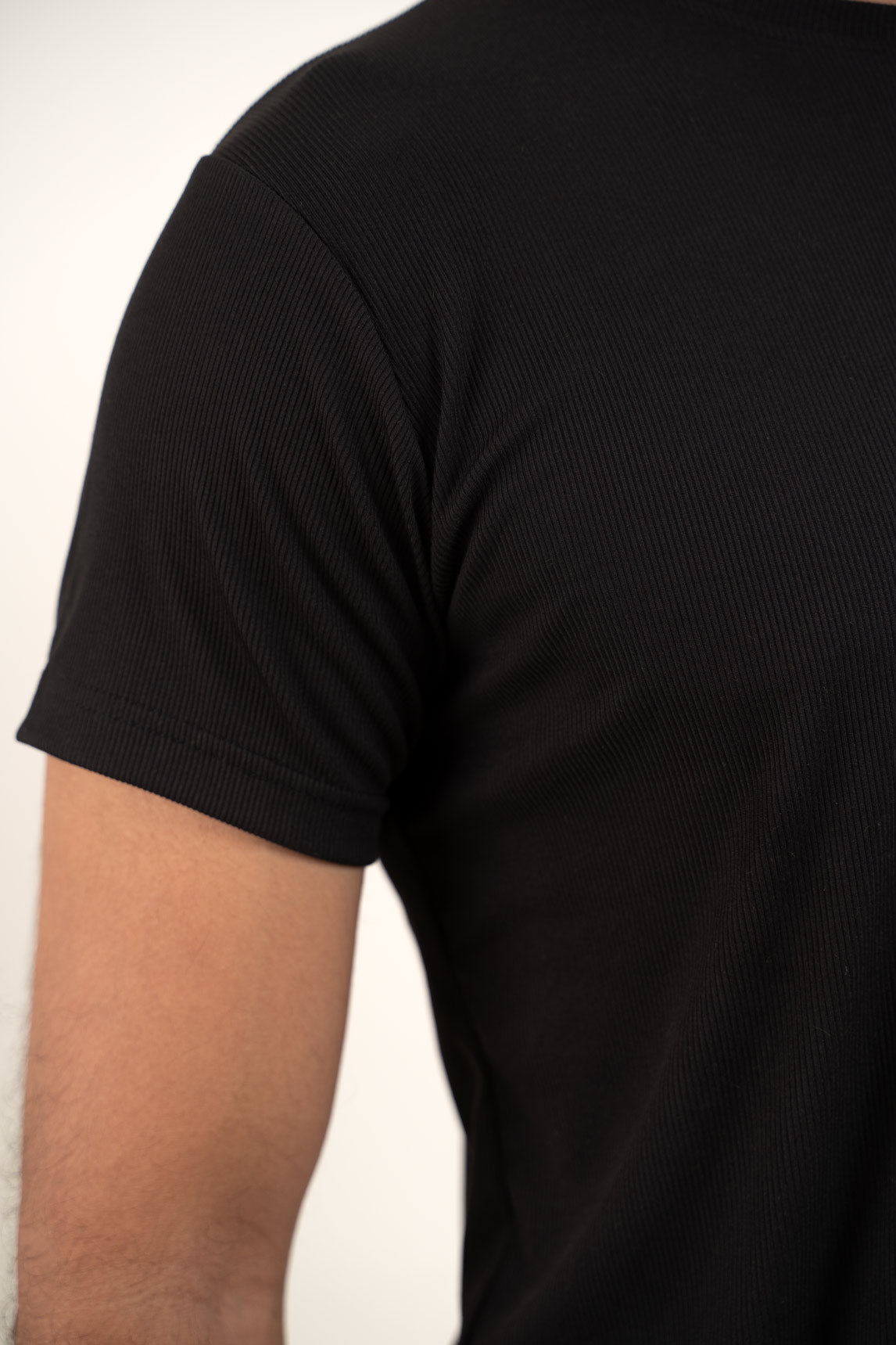 Another detailed view focusing on the sleeve cuffs and hem of the black crewneck tee, adding depth to its design