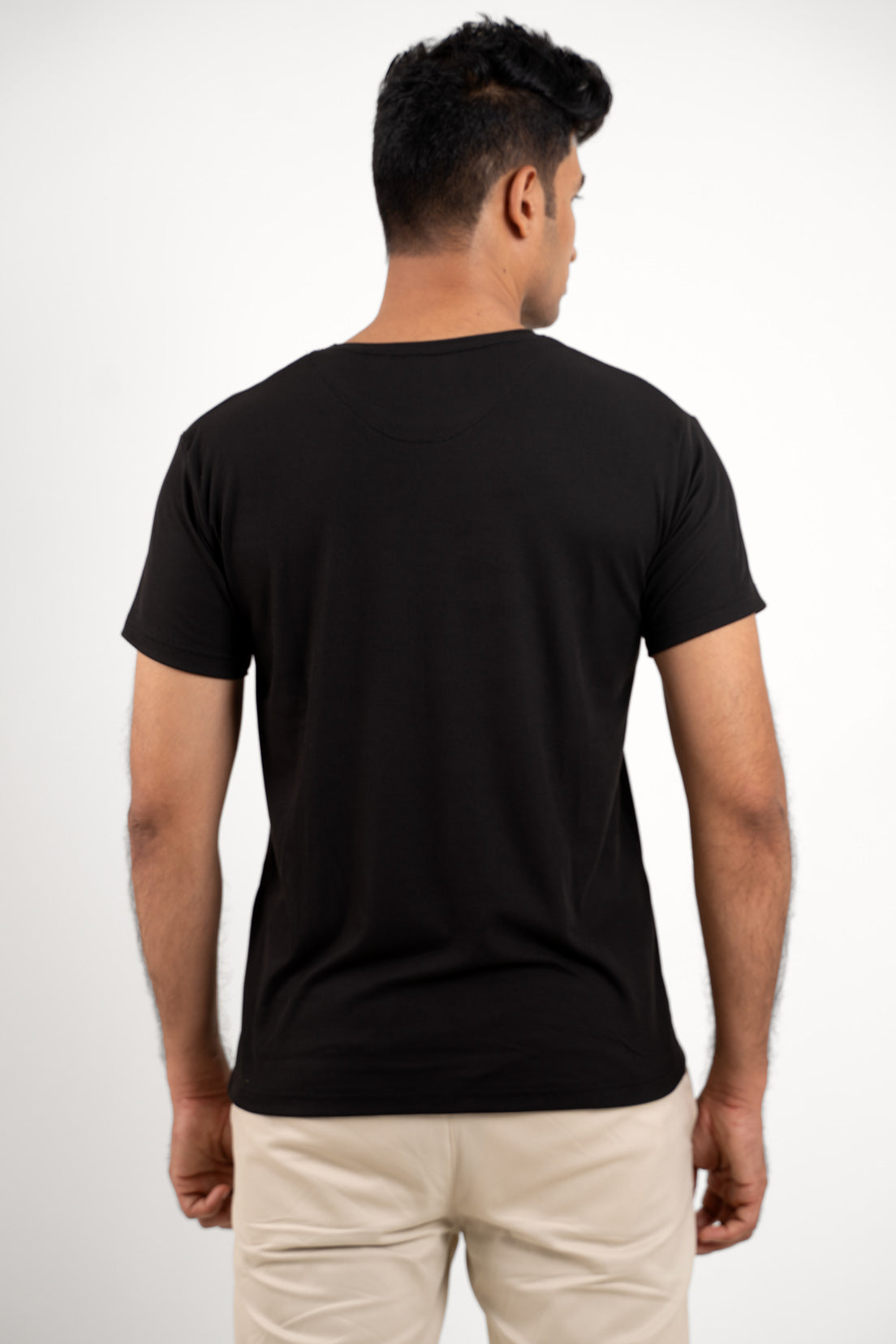 Back view of the essential black crewneck t-shirt, emphasizing its clean lines and essential appeal