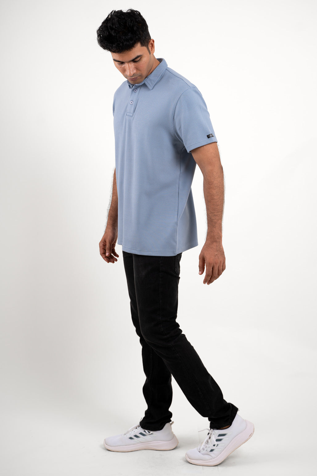 Man wearing a blue polo regular fit t-shirt, front view showing collar and sleeves