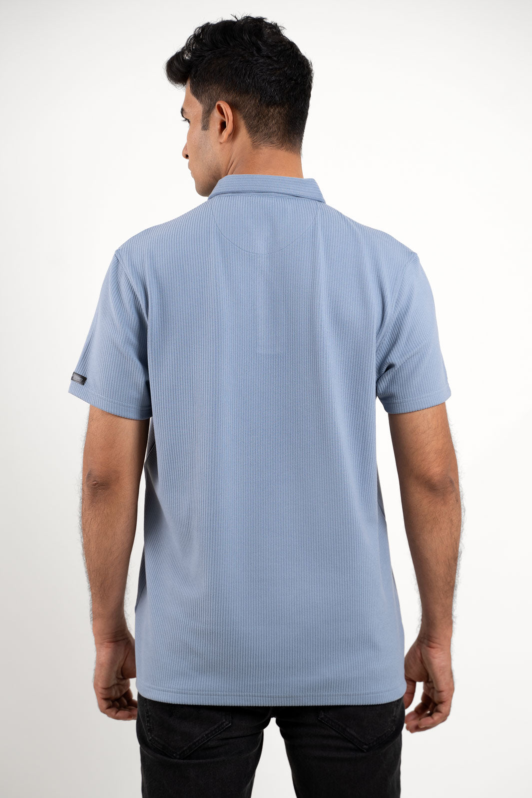 Man in blue polo regular fit t-shirt with short sleeves, back view