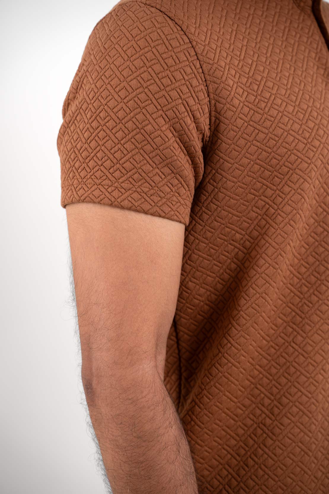 Close up view of Man wearing brown polo t-shirt