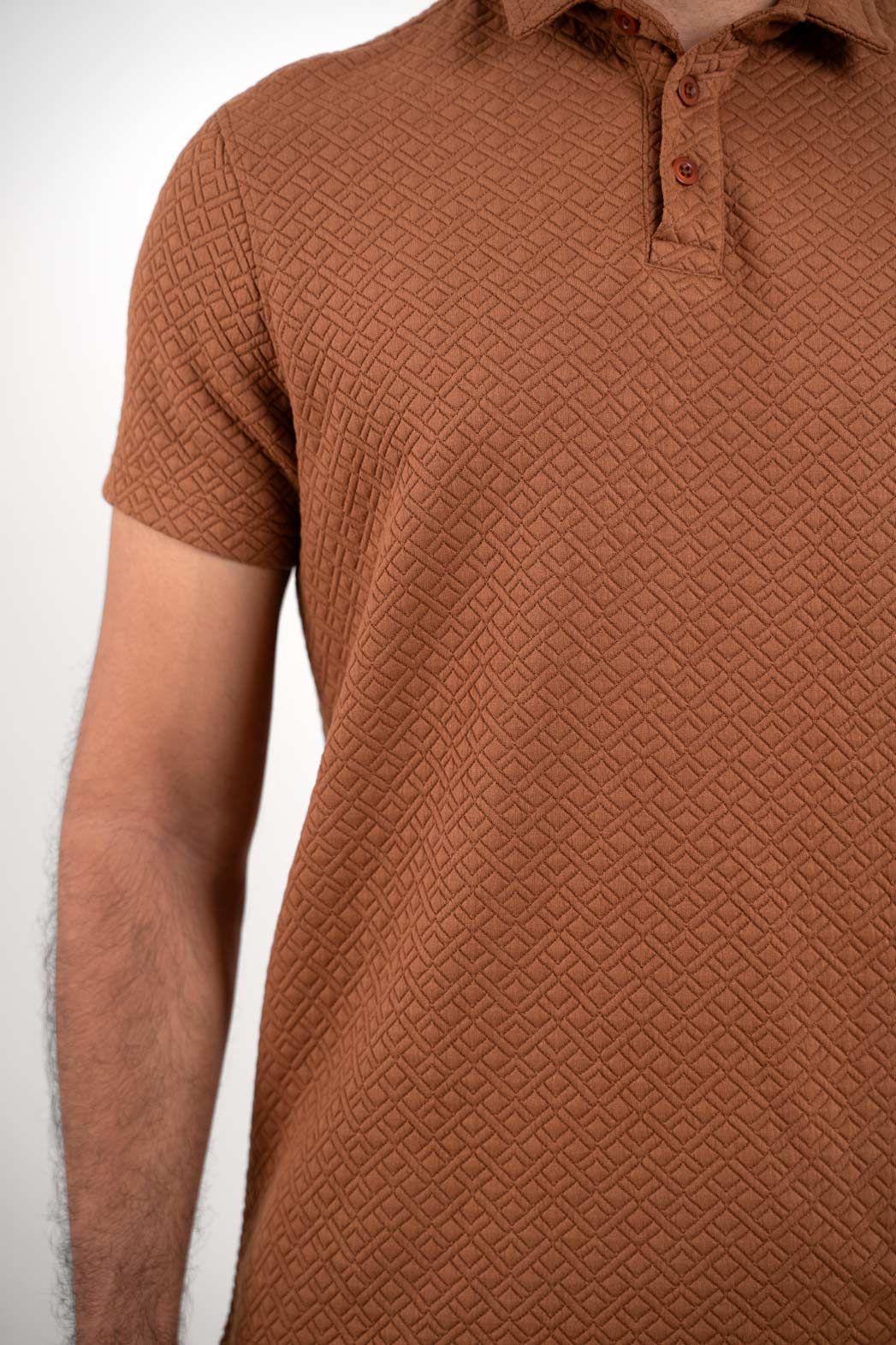 Front view of Man wearing brown polo t-shirt showing collar and buttons