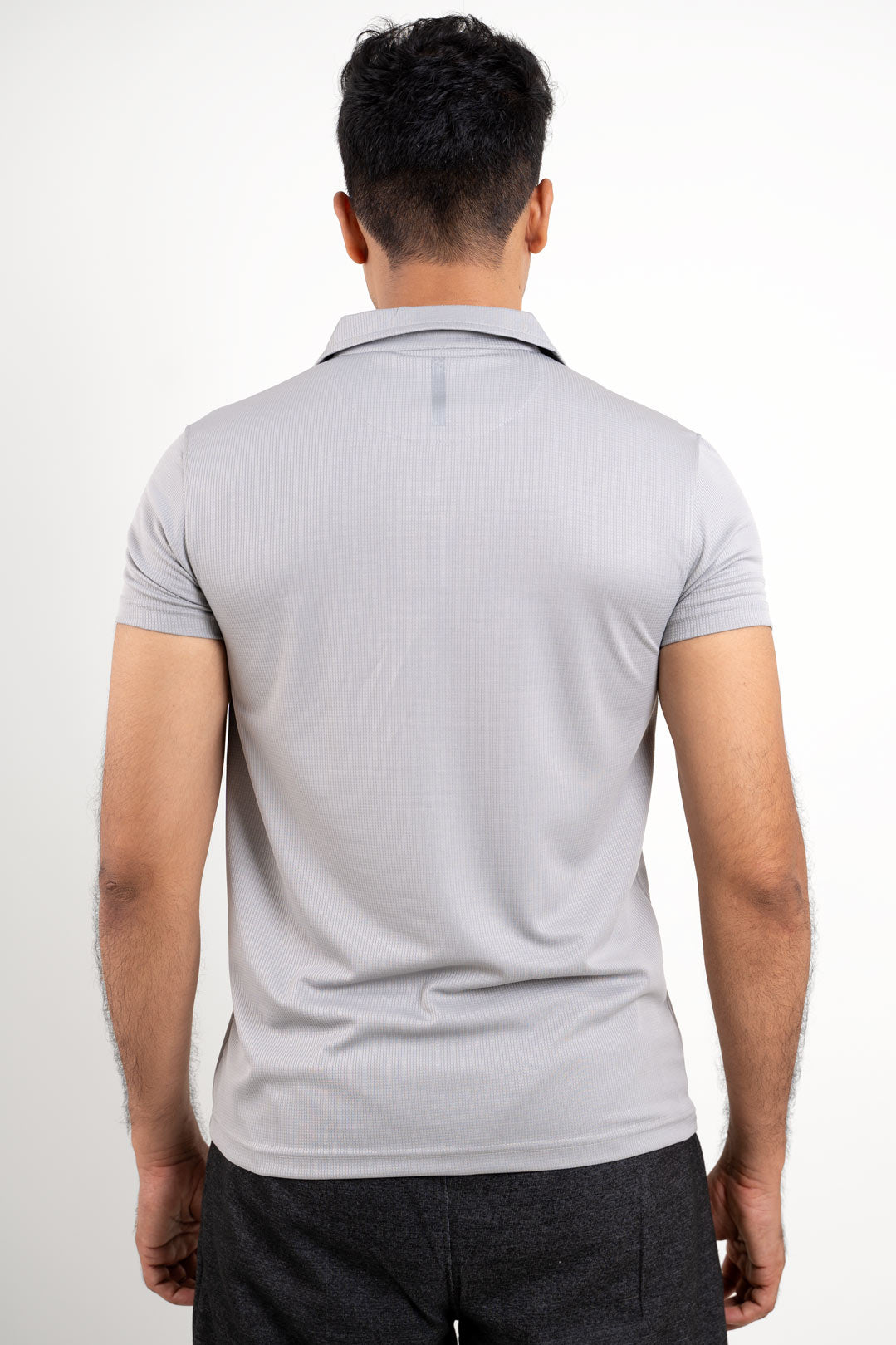 Back view of the active light grey solid polo t-shirt, showcasing its minimalist and clean design