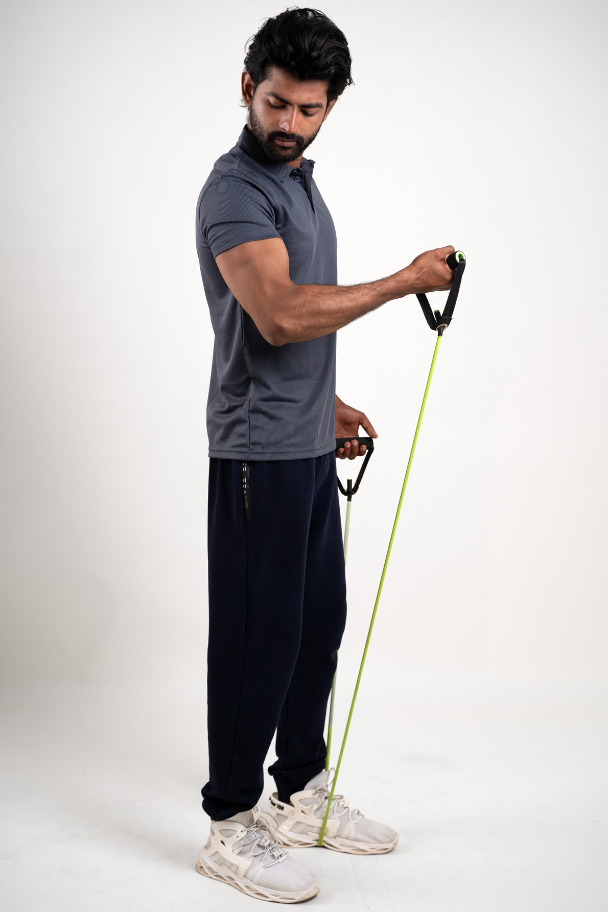 Side angle of the active dark grey polo t-shirt, displaying its ergonomic fit and activewear appeal