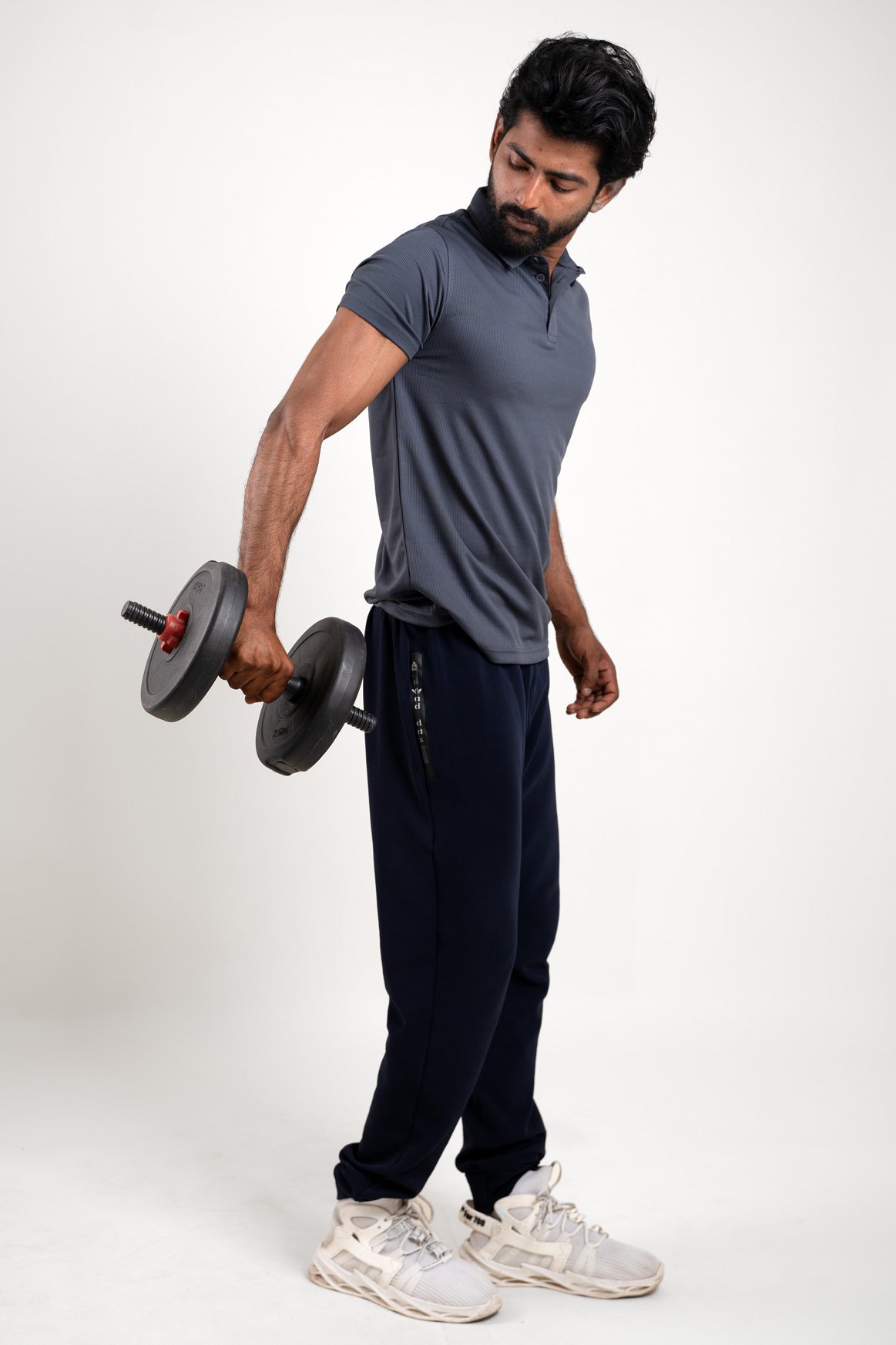 Side angle of the active dark grey polo t-shirt, displaying its ergonomic fit and activewear appeal