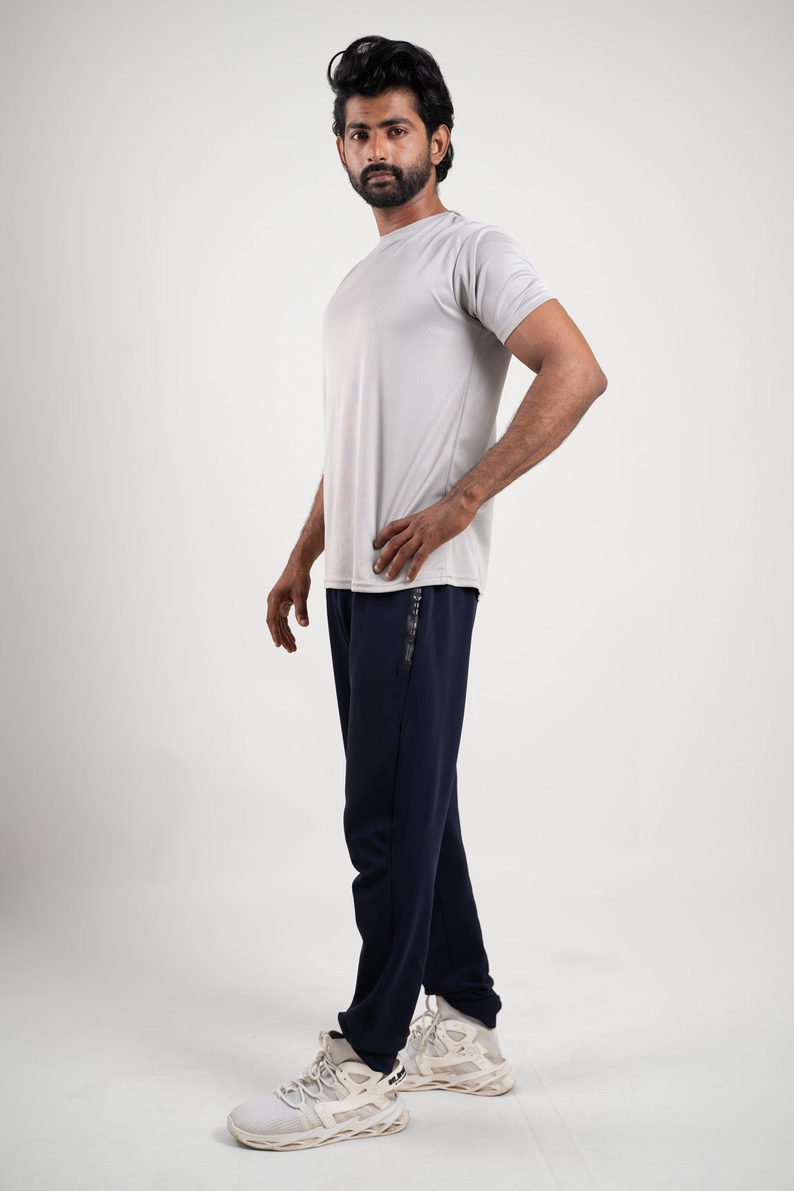 Side view of the active light grey polo t-shirt, displaying its tailored fit and ergonomic style