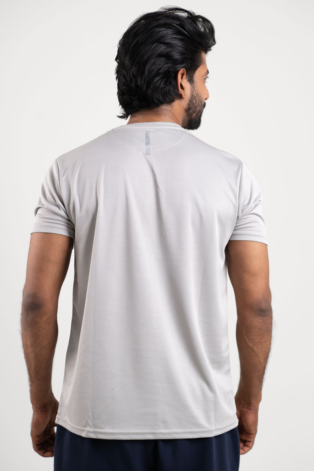 Back view of the active light grey polo t-shirt, showcasing its minimalist and clean design