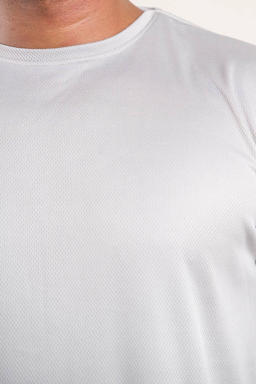 Detailed view of the collar and buttons on the light grey polo t-shirt, emphasizing its fine craftsmanship