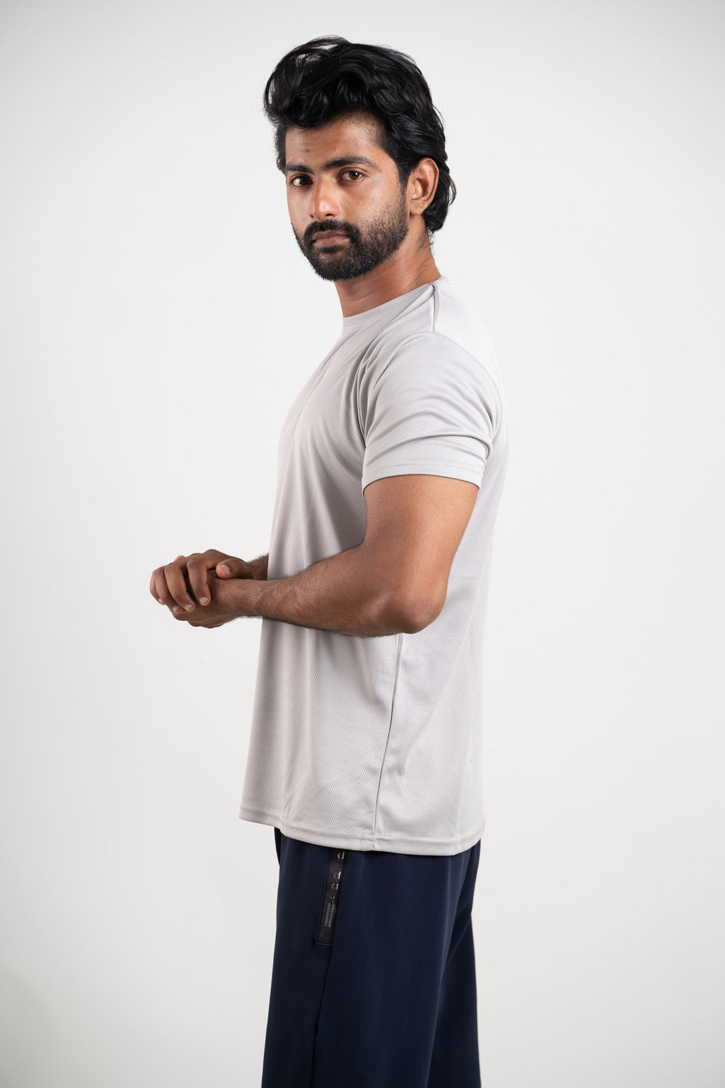 Side view of the active light grey polo t-shirt, displaying its tailored fit