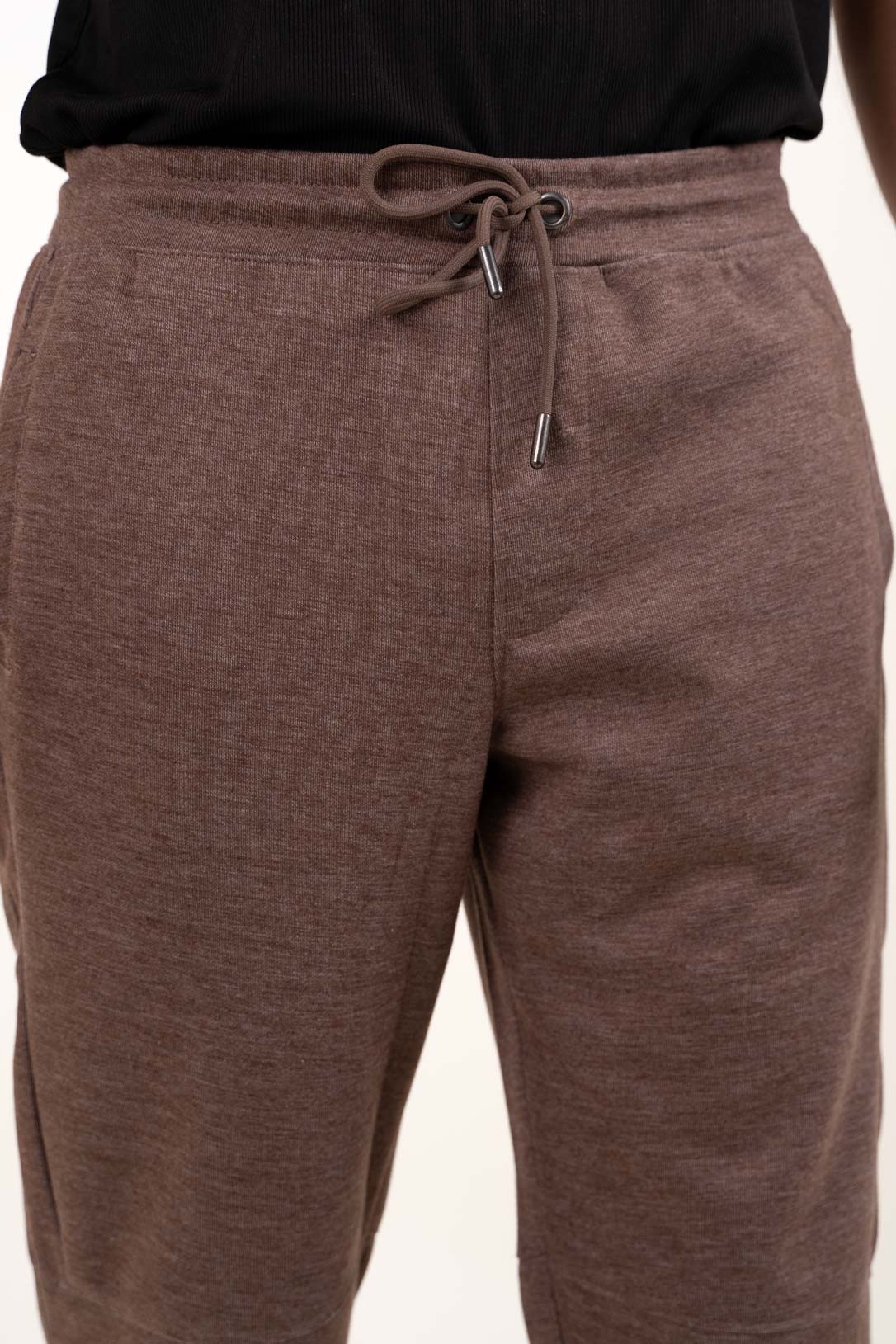 Front Closeup view of the brown jogger pants, showcasing their relaxed fit and versatile style