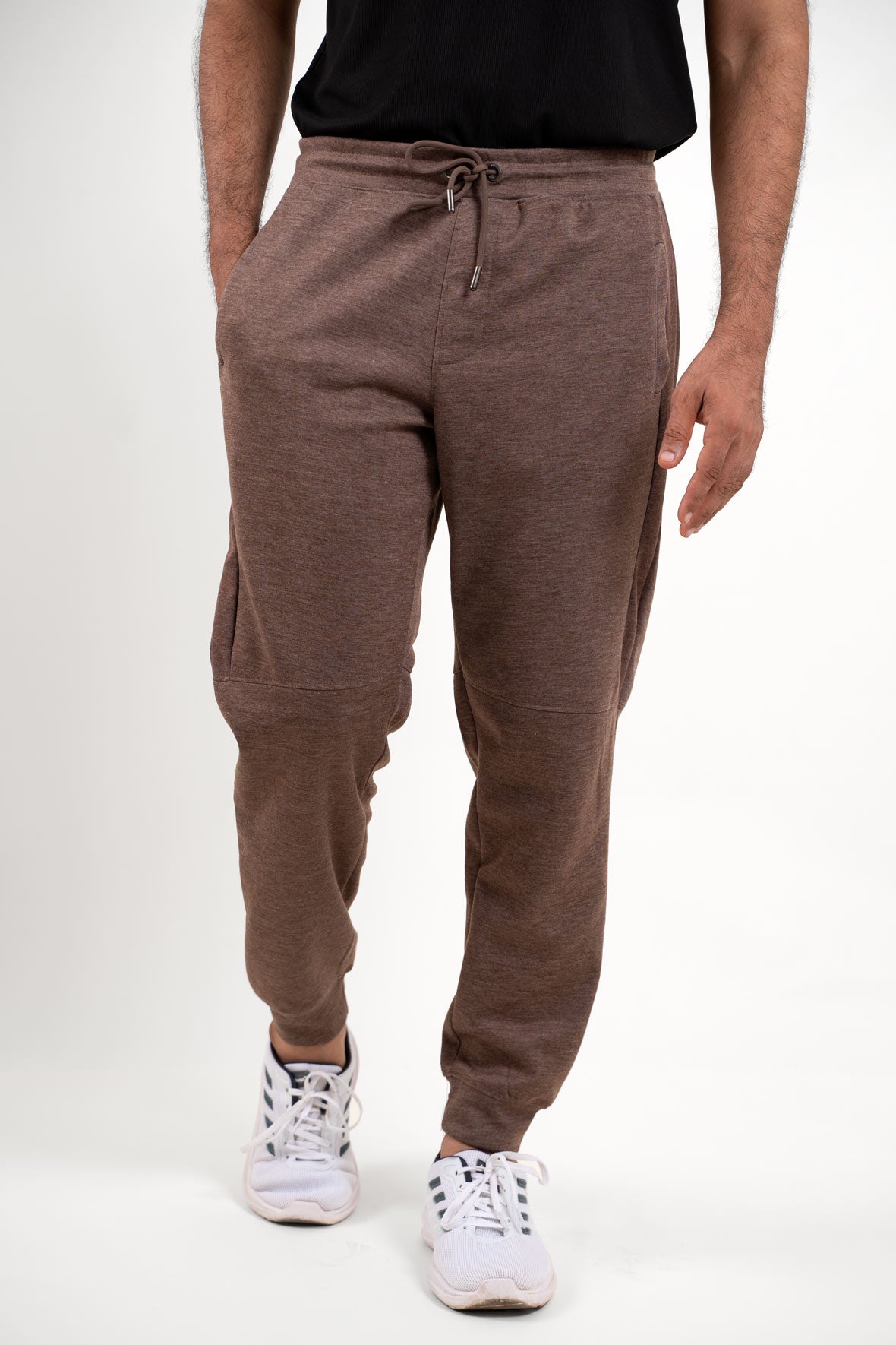 Front view of a stylish pair of brown jogger pants, featuring a comfortable and modern design