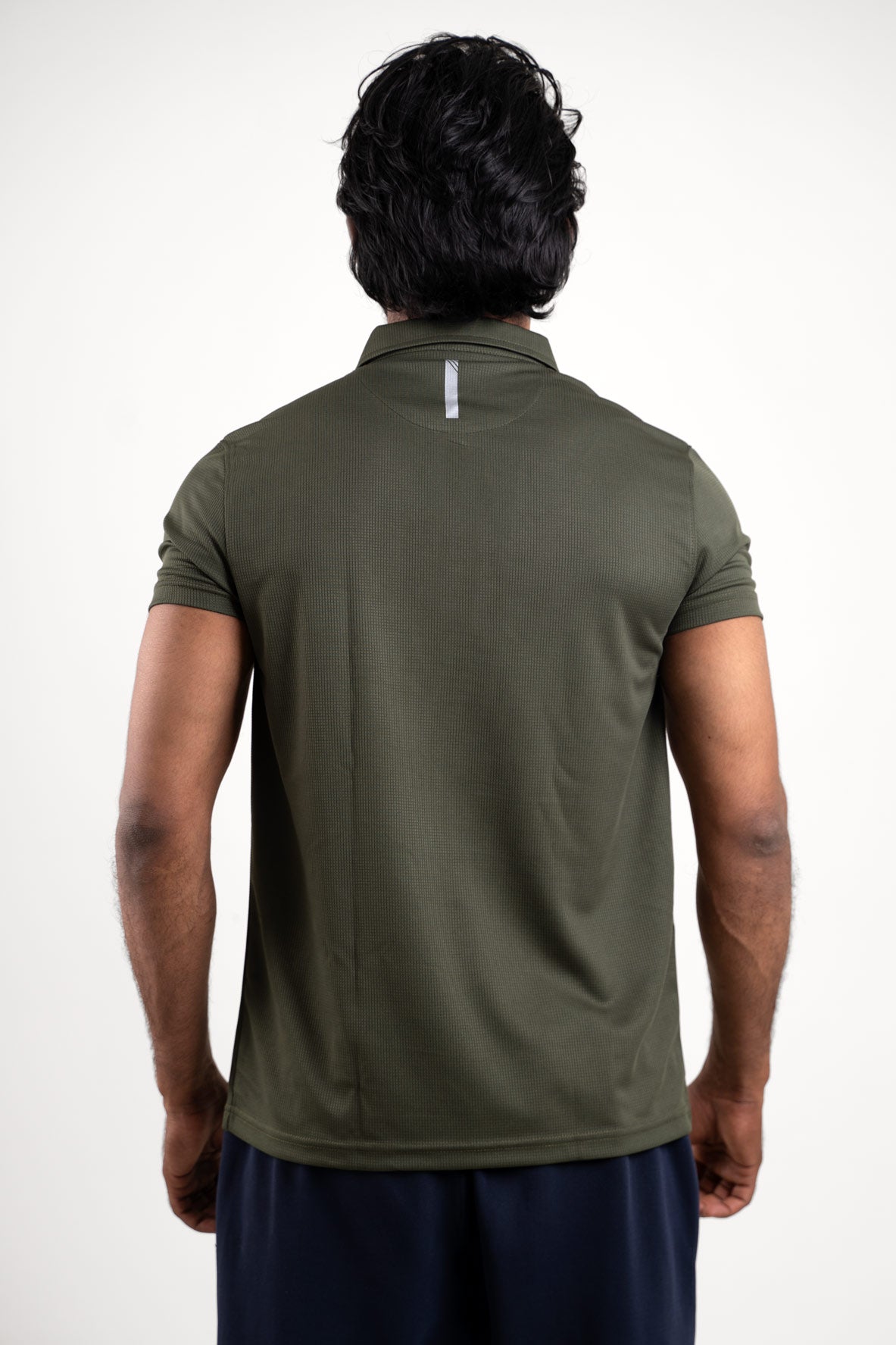 Back view of the active dark olive polo t-shirt, emphasizing its clean and minimalist look