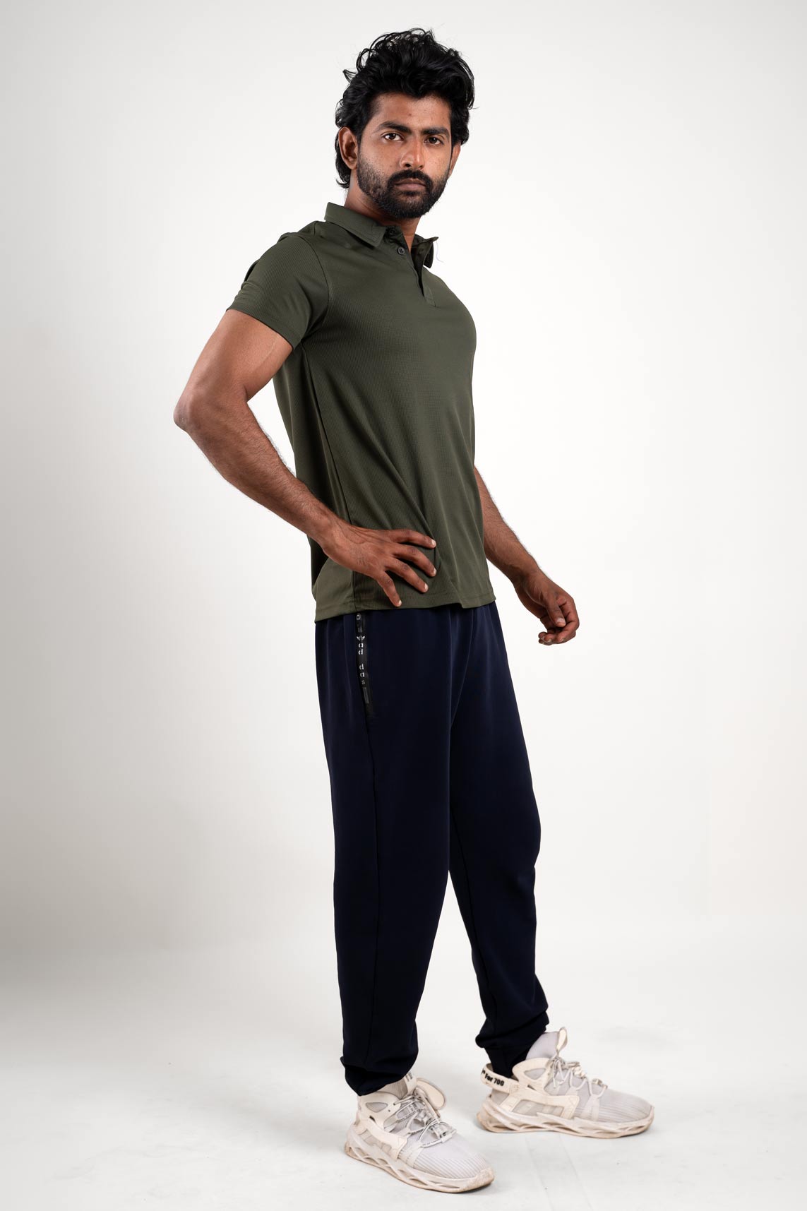 Overall view of the dark olive polo shirt, capturing its athletic style and versatile appeal