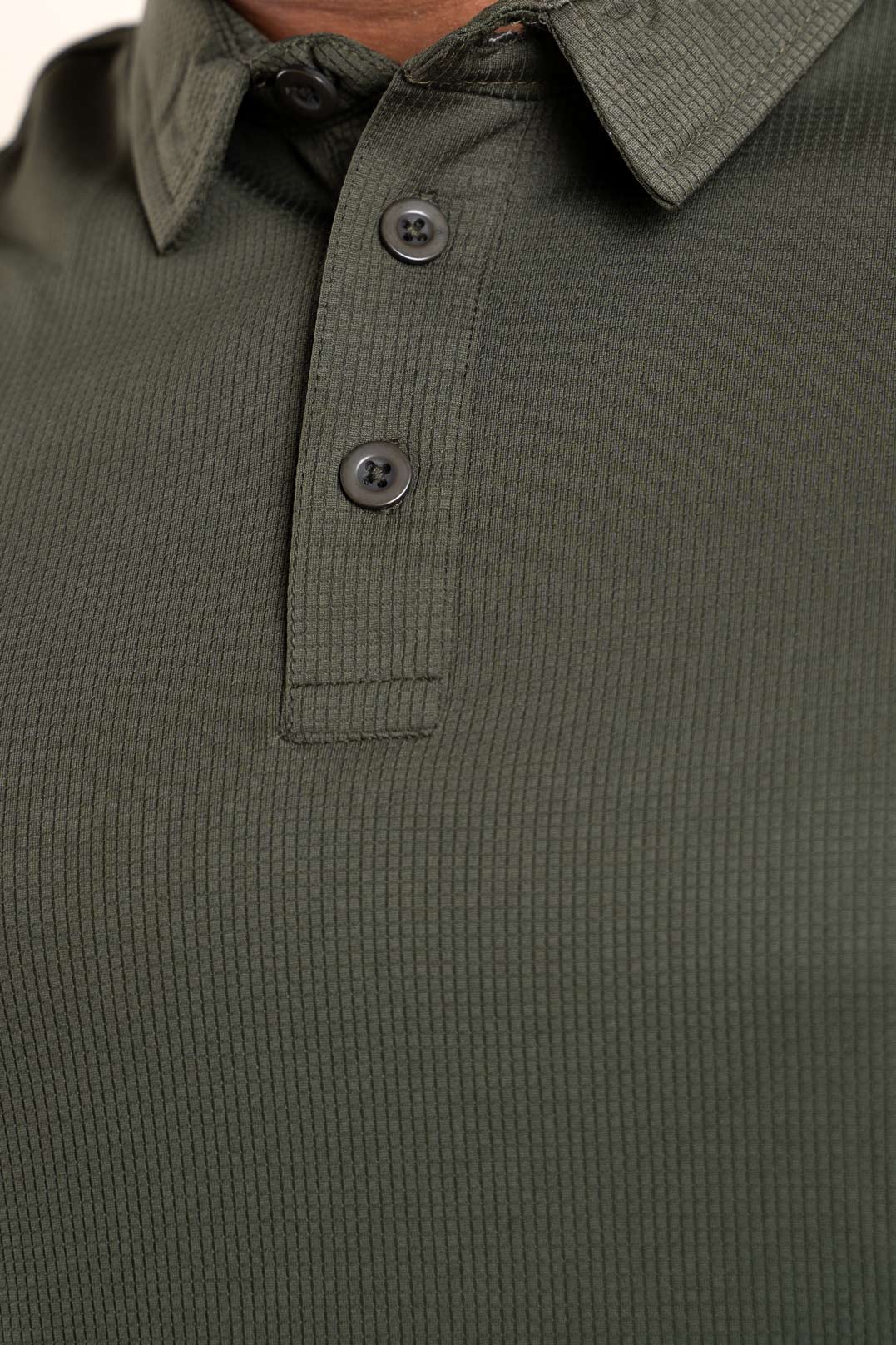 Detailed close-up of the active dark olive polo shirt's texture, revealing its high-quality material