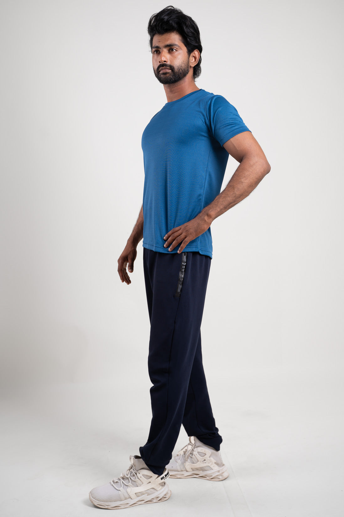 Side view of the active blue crew neck t-shirt, highlighting its fitted silhouette and stylish appearance