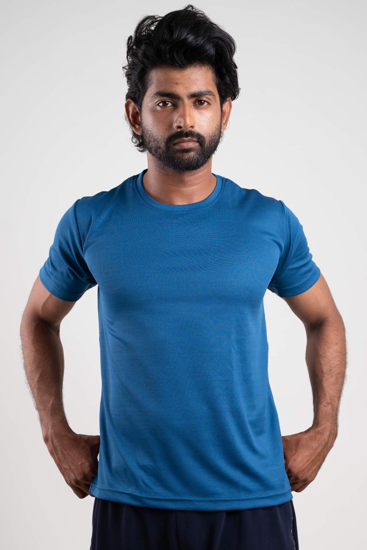 Front view of an active blue crew neck t-shirt, featuring a sleek and sporty design