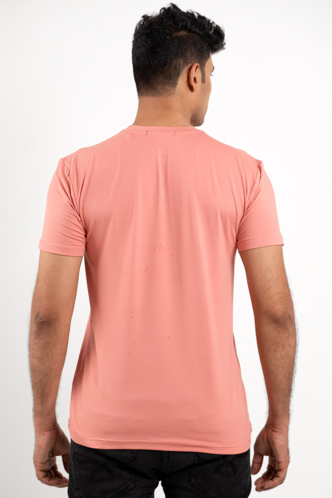 Back view of the peach Henley t-shirt, showcasing its simple and sleek design