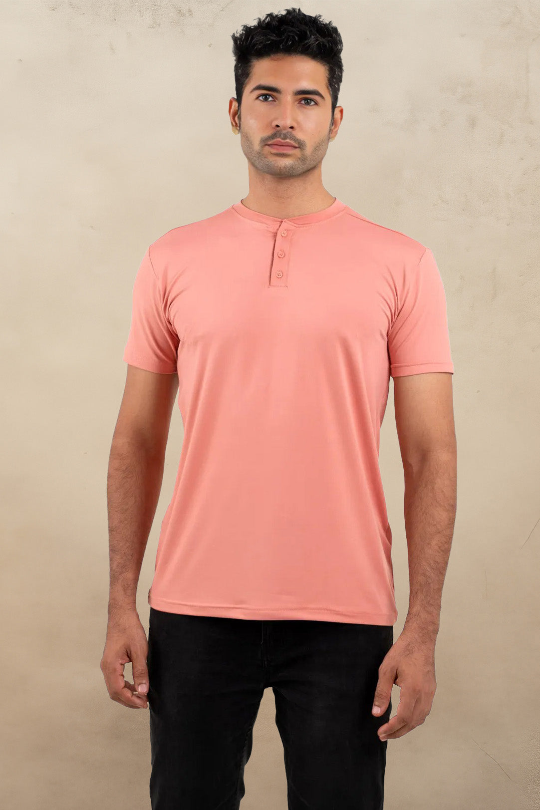 Front view of a peach Henley solid t-shirt, featuring a classic buttoned neckline