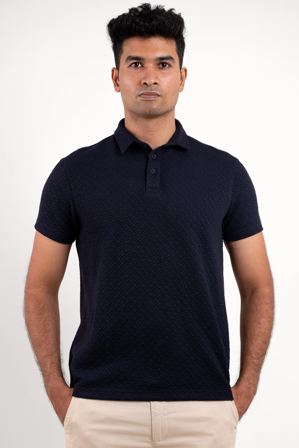 Front view of a textured solid navy blue polo t-shirt, featuring a sleek and sophisticated design