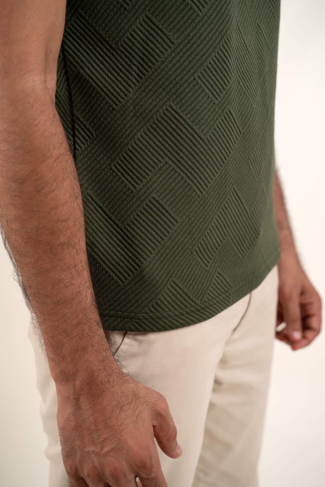 Man's textured green polo t-shirt, front view highlighting breathable and stylish fabric