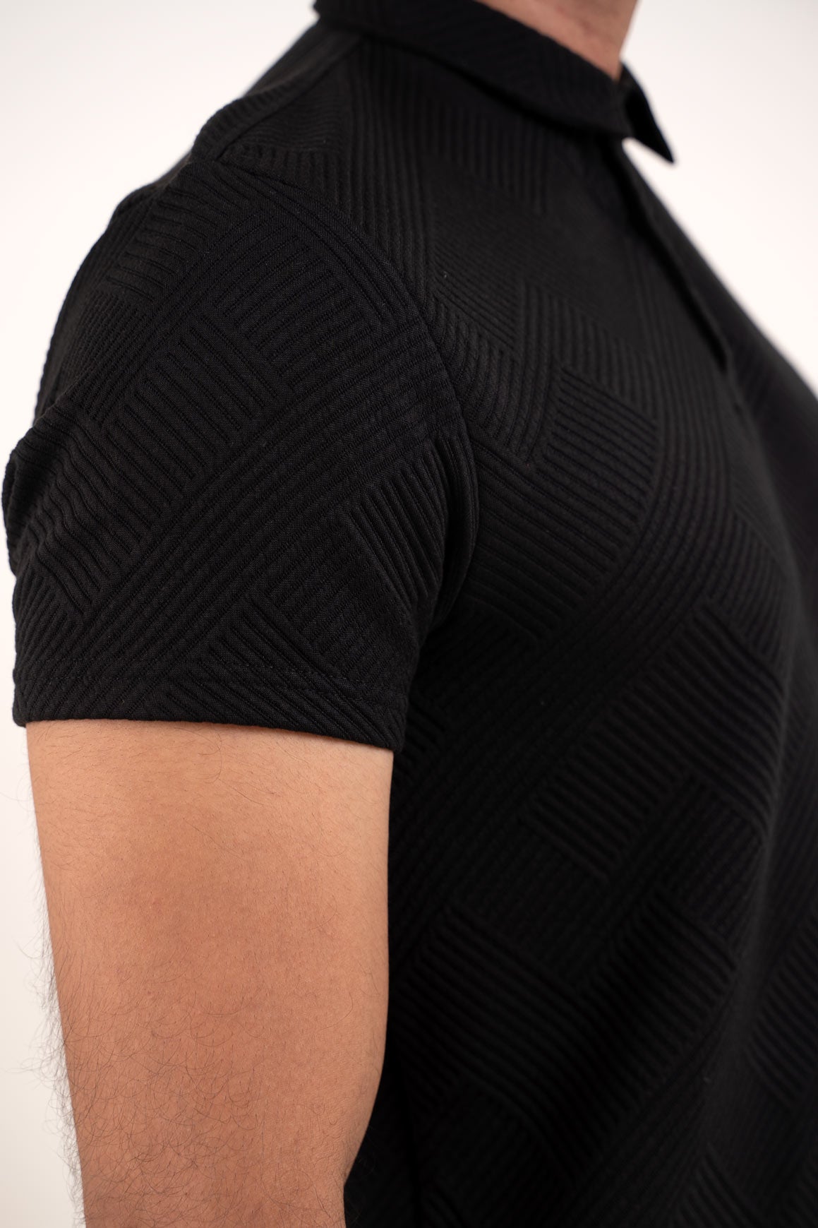 Close-up shot of the black solid t-shirt fabric, showcasing its quality and texture