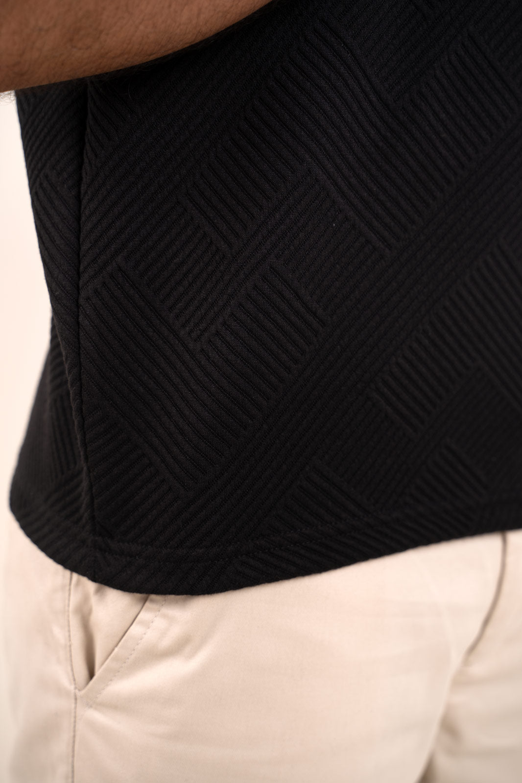 Detailed shot of the black solid t-shirt's stitching and seams for durability