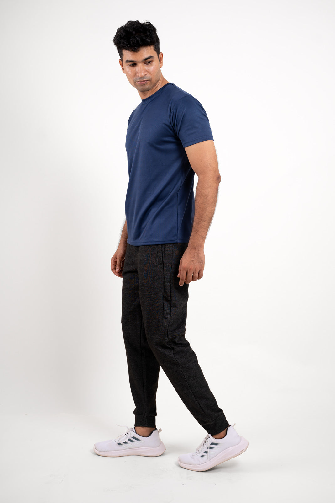 Profile view of the navy blue crew neck t-shirt, showcasing its contemporary design and athletic fit