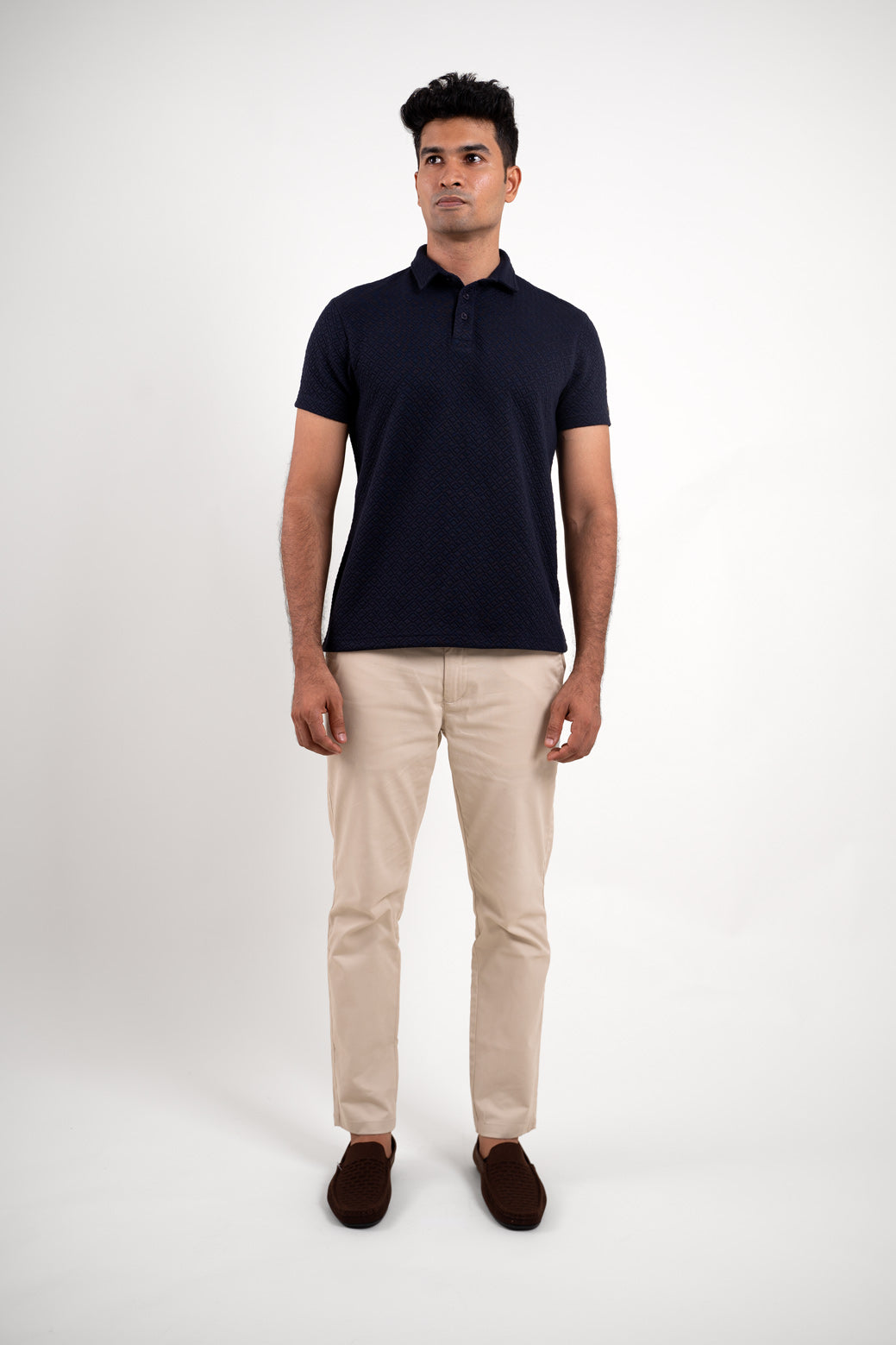 Full-length image of the textured navy blue polo t-shirt, providing a comprehensive look at its overall design