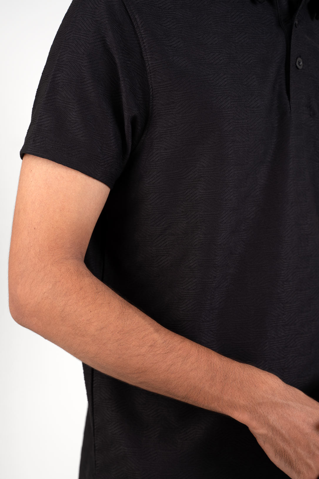 Black polo t-shirt worn by man, front view