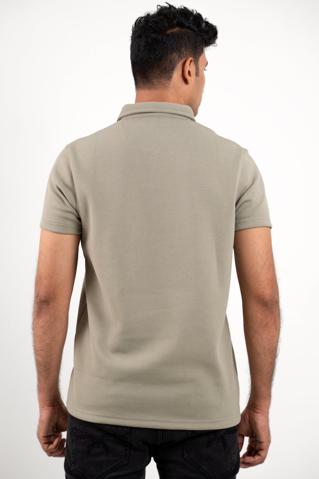 Back view of the solid light green polo shirt, emphasizing its clean lines and smooth finish