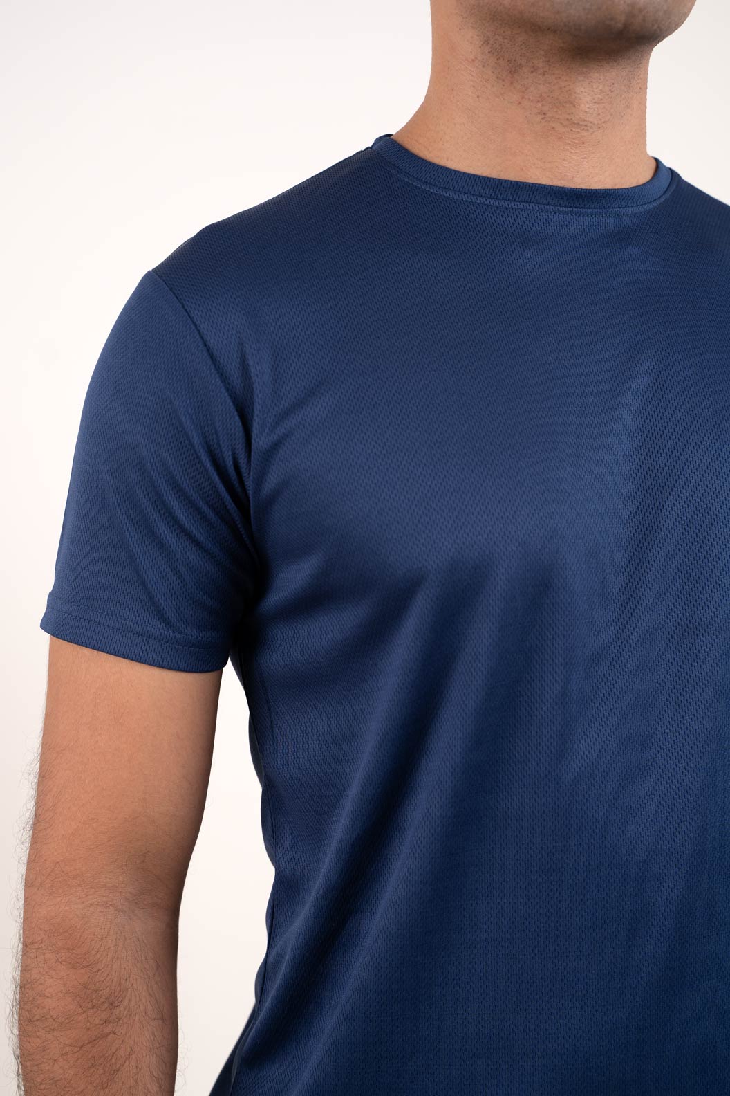 Detailed close-up of the active navy blue crew neck t-shirt's texture, highlighting its high-quality material