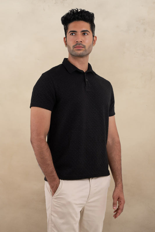 Front view of a textured solid black polo t-shirt, featuring a sleek and sophisticated design