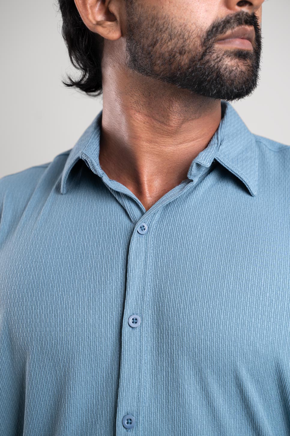 Closeup view of man wearing blue shirt