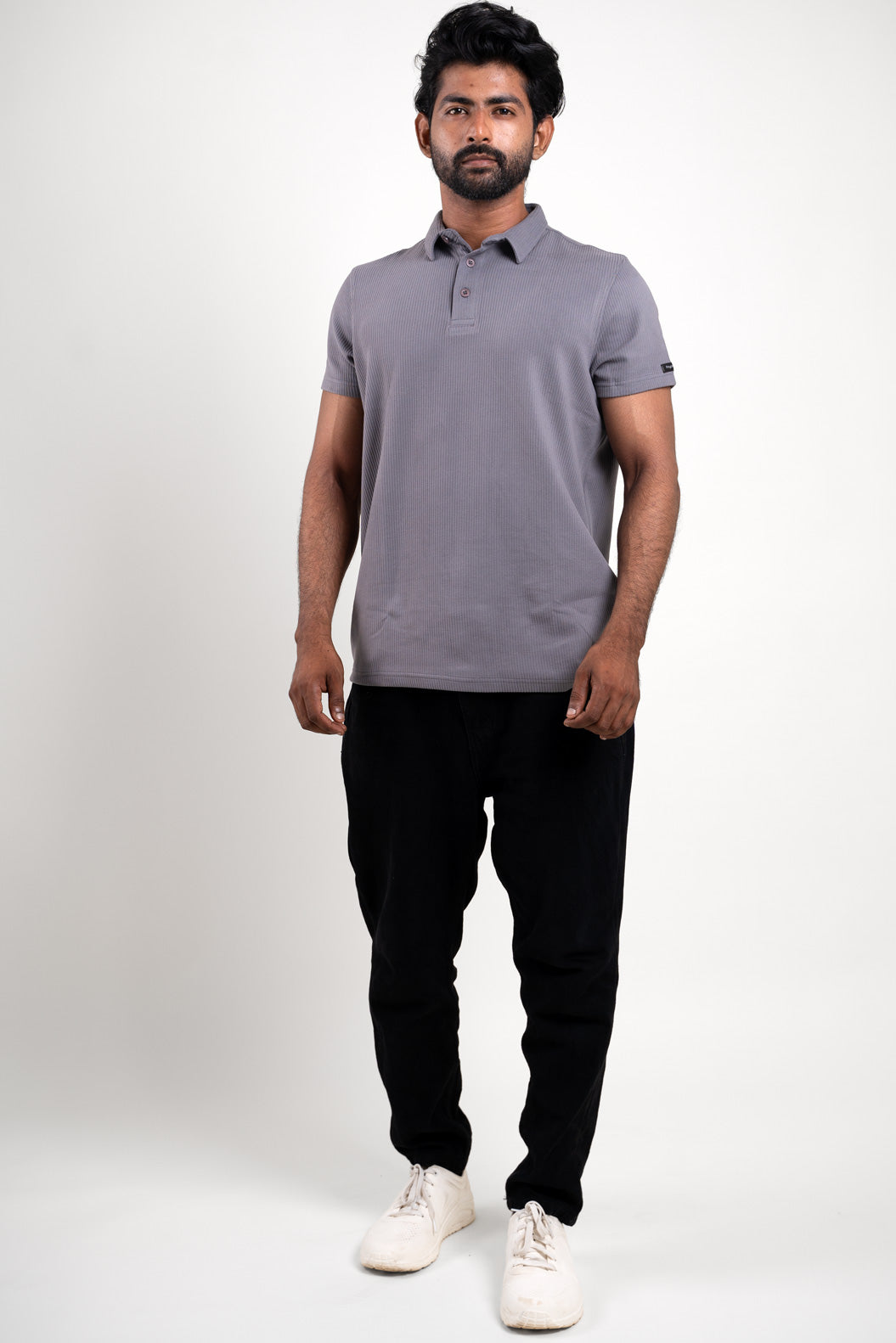 Grey polo t-shirt worn by man, front view with no logos or patterns