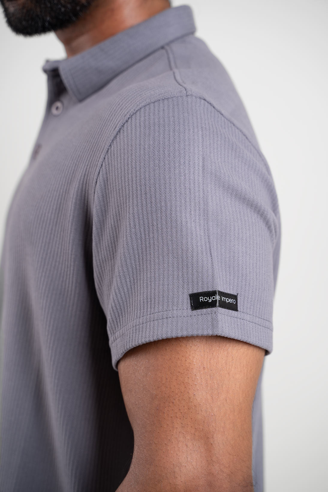 Grey polo t-shirt worn by man, front view highlighting soft fabric texture