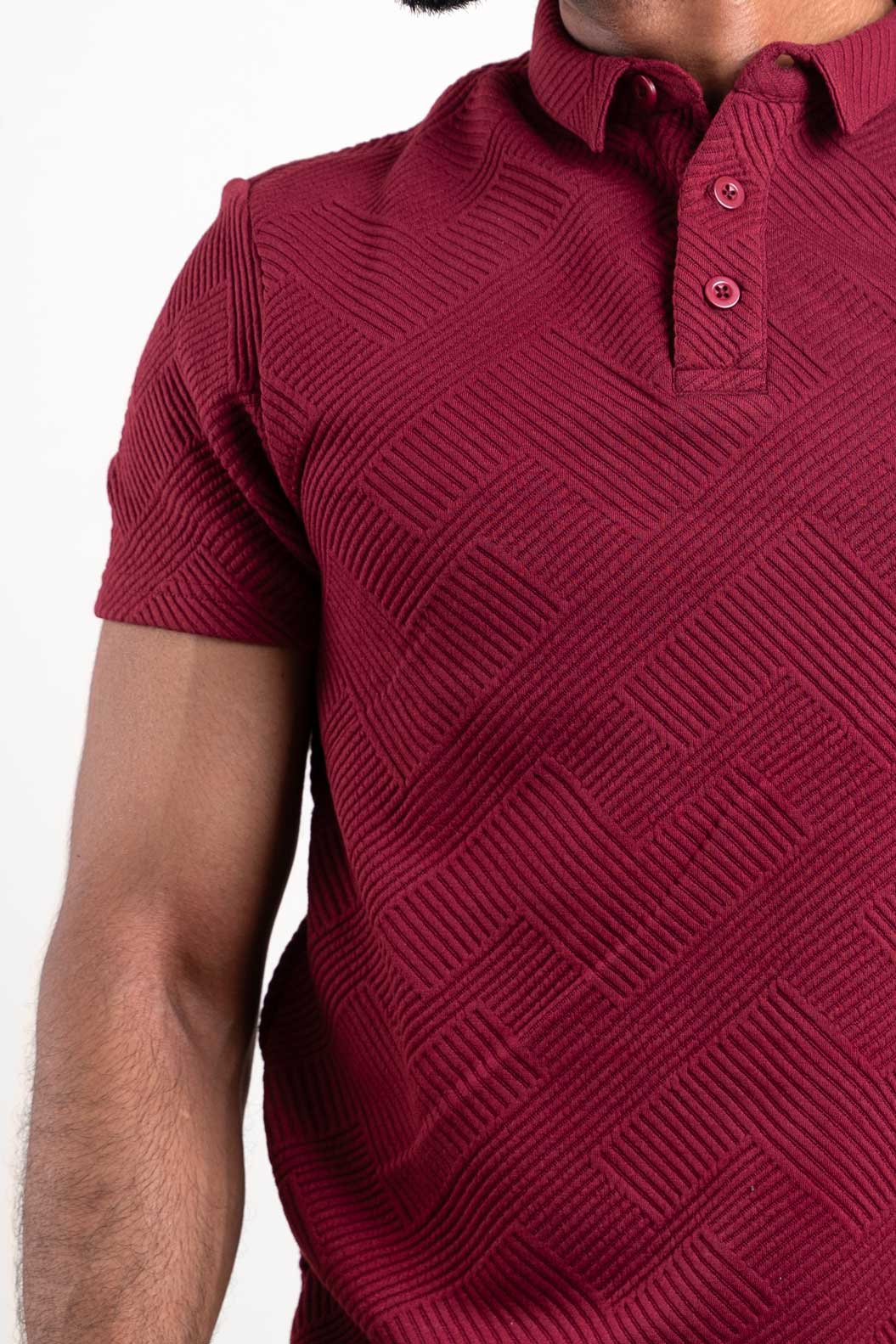 Close-up of the red textured polo's collar and buttons, showcasing its attention to detail