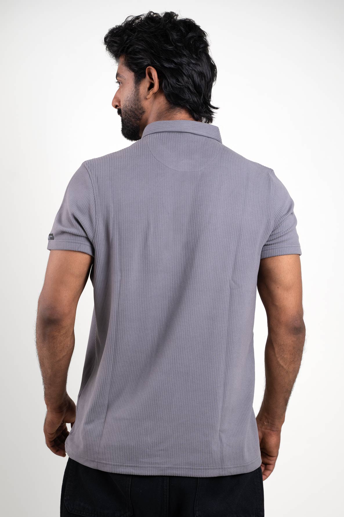 Man wearing a grey polo t-shirt, back view emphasizing minimalist style