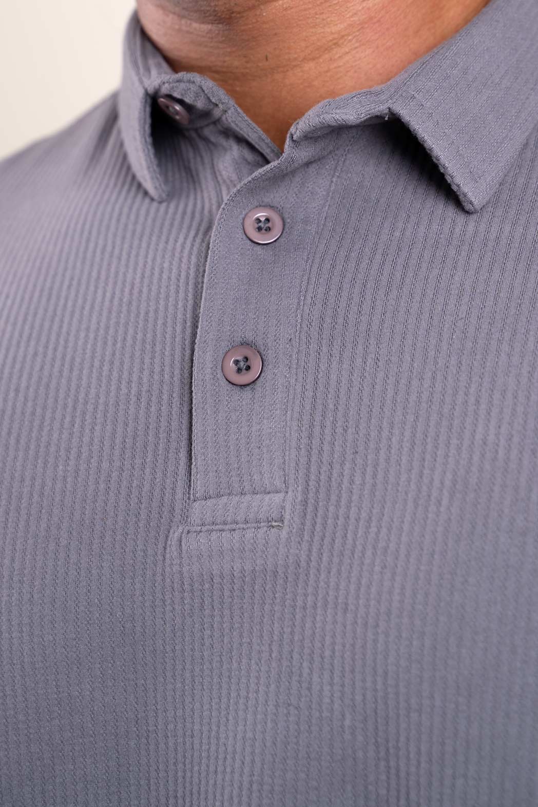 Grey polo t-shirt worn by man, front view highlighting soft fabric texture