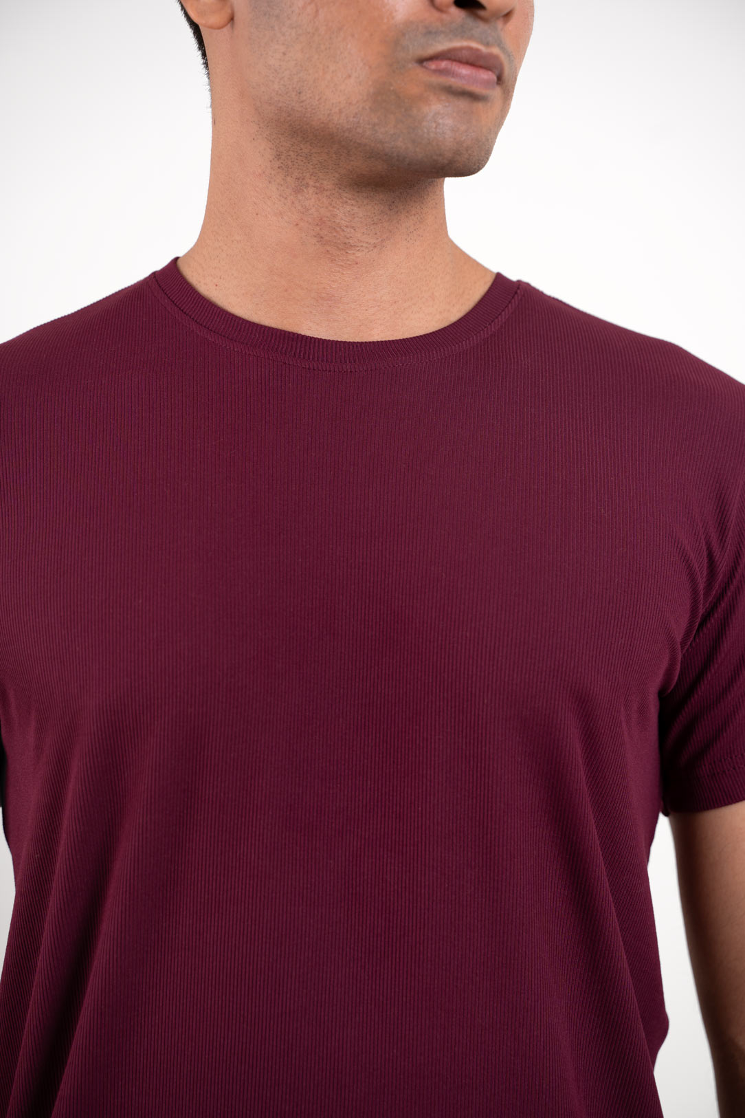 Detailed close-up of the stitching and neckline of the red crewneck tee, showcasing its quality construction