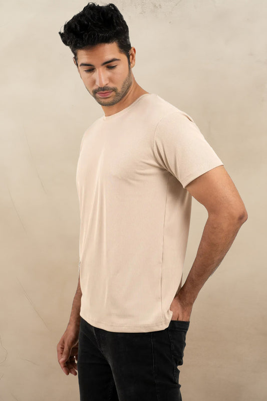 Side angle of the beige crewneck t-shirt, displaying its effortless versatility and everyday comfort