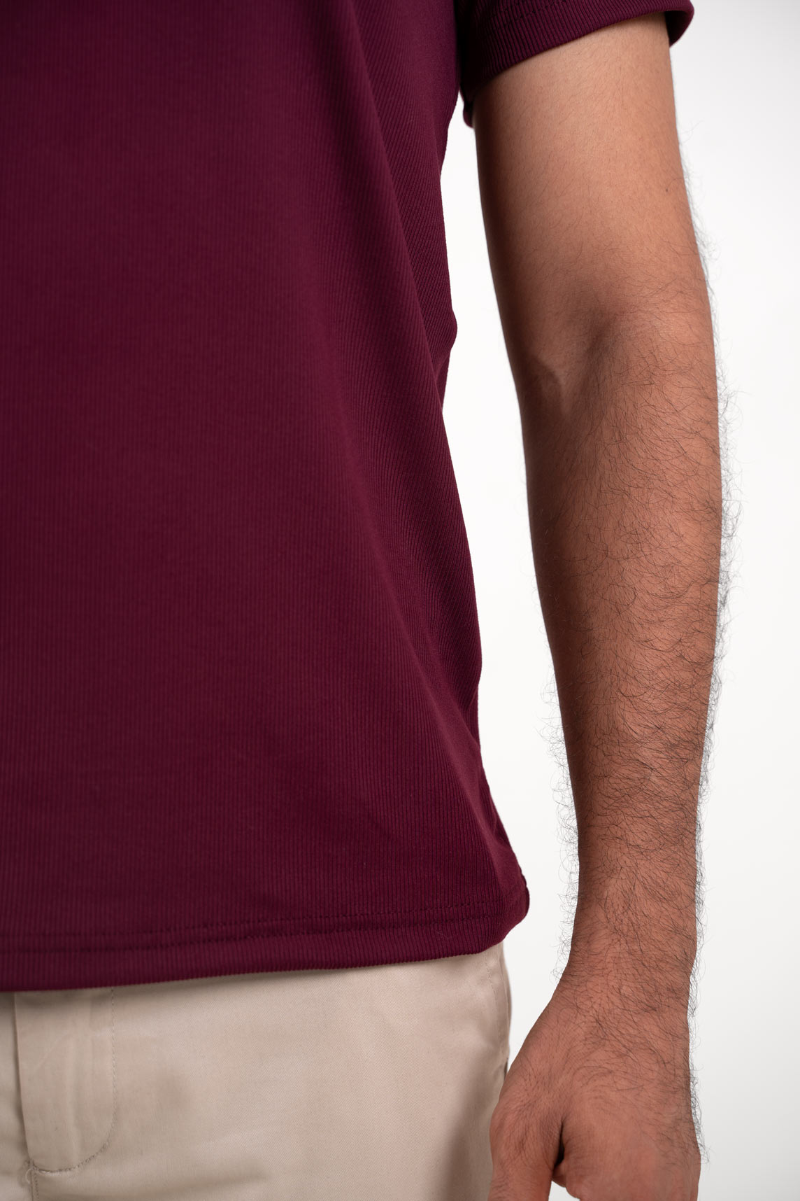 Another detailed view focusing on the sleeve cuffs and hem of the red crewneck tee, adding depth to its design