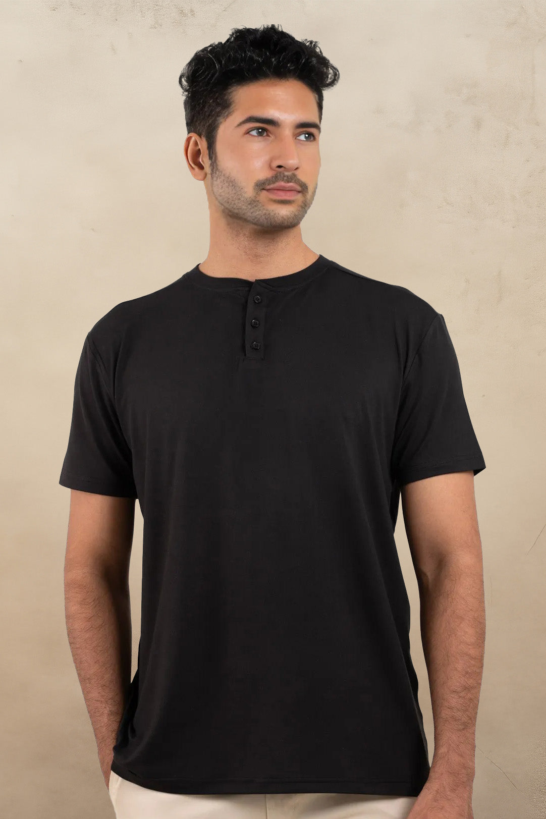 Front view of a classic black Henley t-shirt, featuring a buttoned neckline for a stylish touch