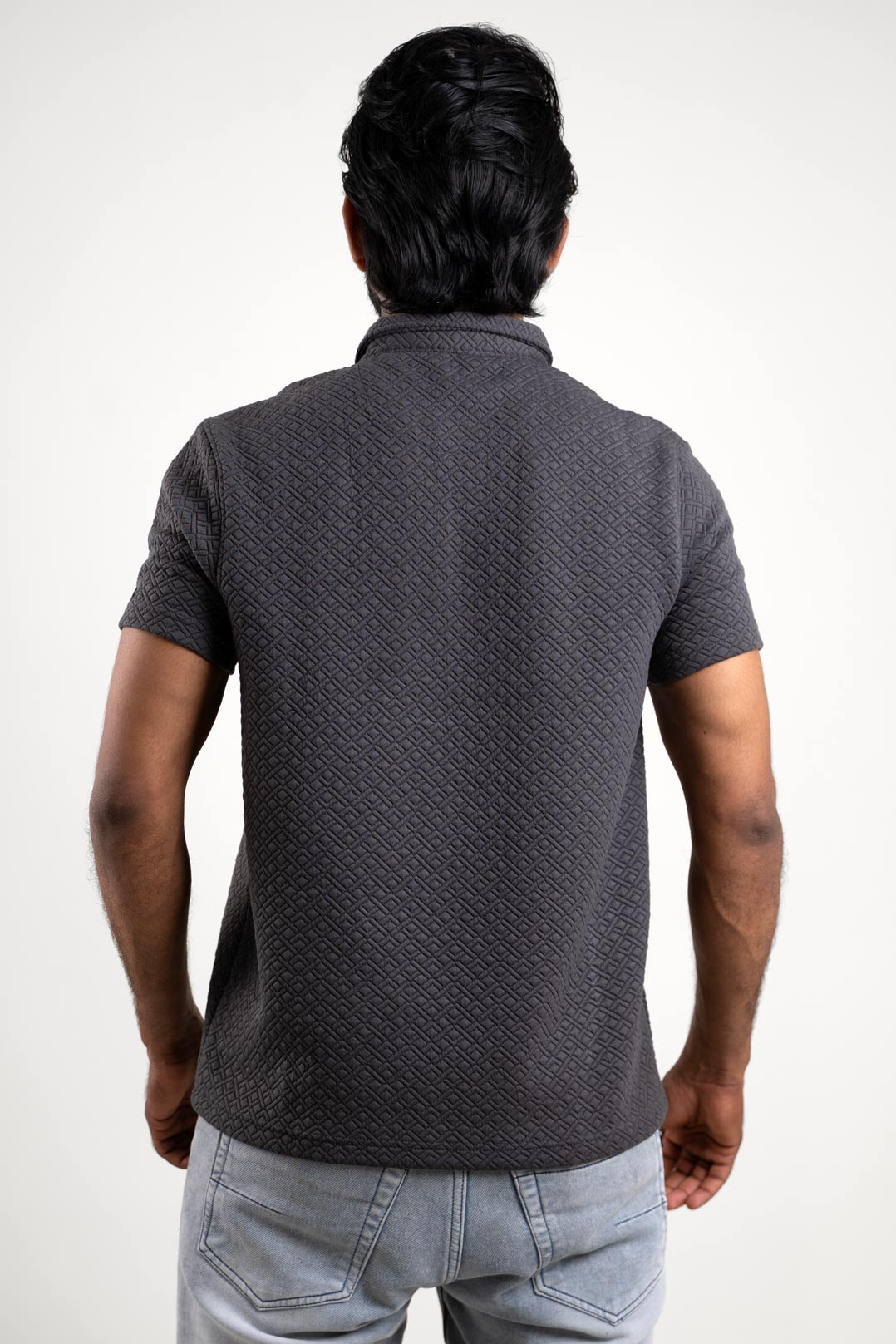 Back view of the textured grey polo t-shirt, highlighting its clean and minimalist appearance